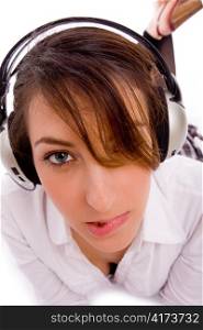 front view of female listening music in headset with white background