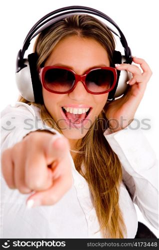 front view of pointing female enjoying music on an isolated background