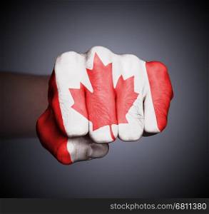 Front view of punching fist on gray background, flag of Canada