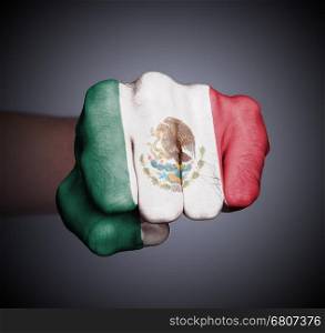 Front view of punching fist on gray background, flag of Mexico