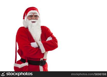 Front view of Santa Claus standing with arms crossed over white background