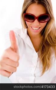 front view of smiling female with thumbs up with white background