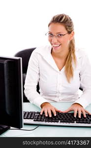 front view of smiling manager working on computer with white background