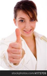 front view of smiling woman with thumbs up against white background