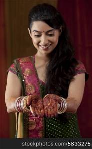 Front view of smiling young bride showing her henna tattoo