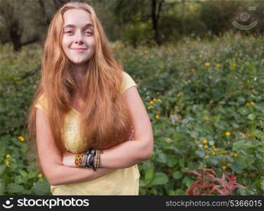Front view of the smiling blond girl. Female against nature background