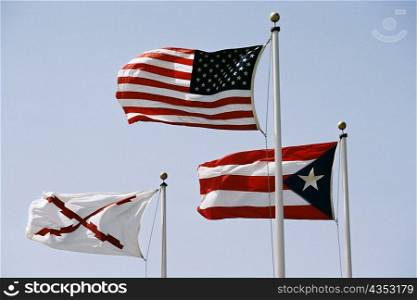 Front view of three fluttering flags, El Morro Fort, San Juan, Puerto Rico
