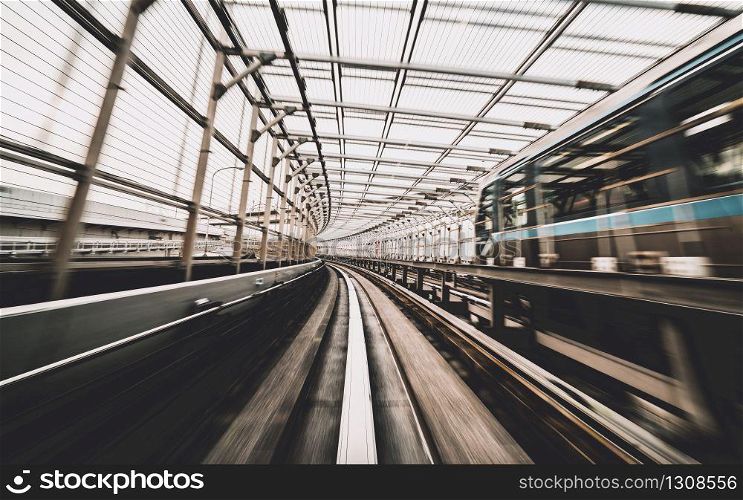 Front view of train moving in city rail tunnel with moderate motion blur and sepia color filter. Transportation concept and motion blur background abstract.