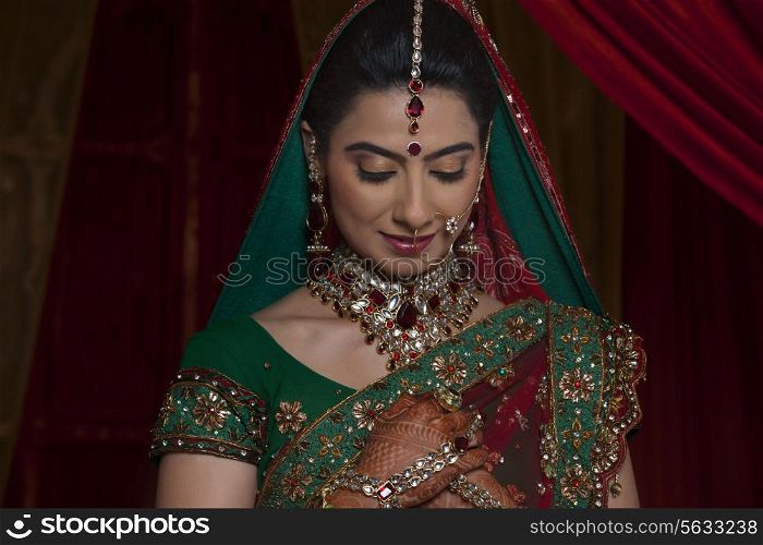 Front view of young Indian bride looking down