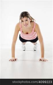 front view of young woman doing push-ups