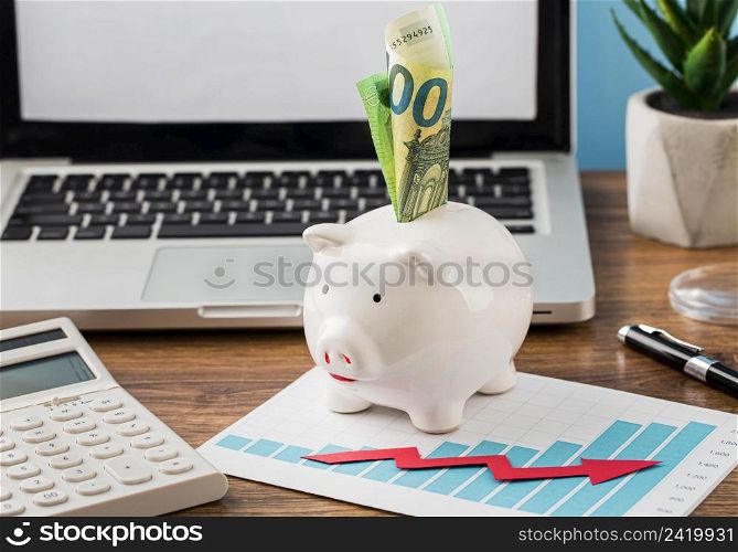 front view office items with piggy bank growth chart