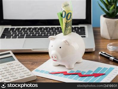 front view office items with piggy bank growth chart