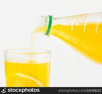 front view orange juice being poured glass from bottle