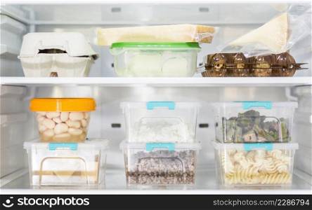 front view organized plastic food containers fridge