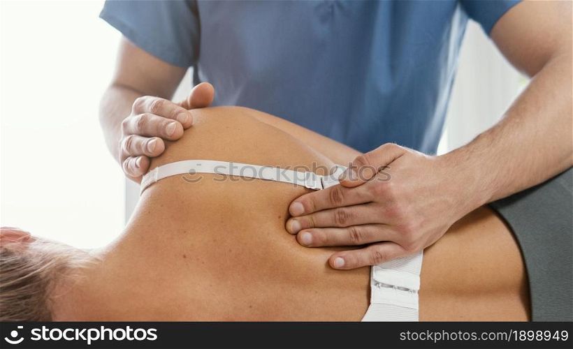 front view osteopathic therapist checking female patient s back 2. Resolution and high quality beautiful photo. front view osteopathic therapist checking female patient s back 2. High quality beautiful photo concept
