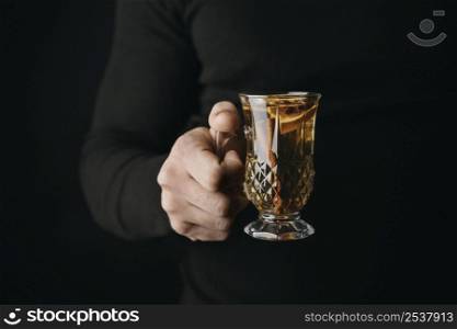 front view person holding glass with winter drink