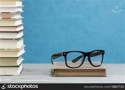 front view pile books with glasses