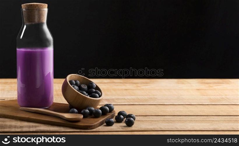 front view purple smoothie blueberries with copy space