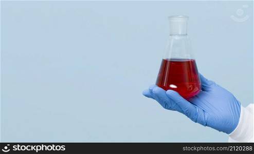 front view scientist holding red chemical with copy space