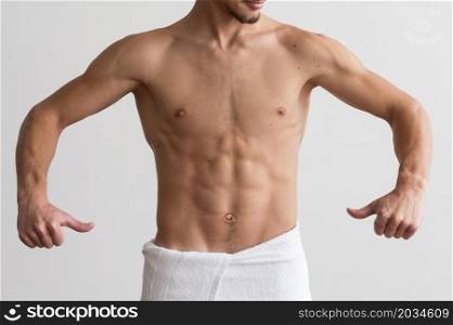 front view shirtless man showing off his abs