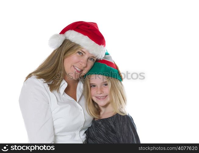 Front view, shoulders up, of mother and her young daughter wearing Christmas hats isolated on a white background