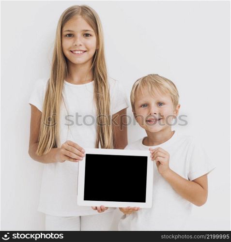front view siblings holding tablet mock up