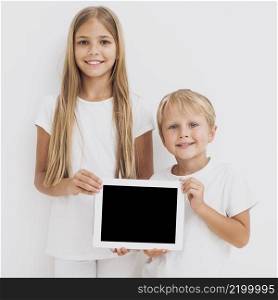 front view siblings holding tablet mock up