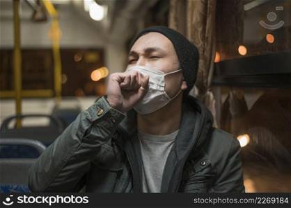front view sick man coughing bus while wearing medical mask