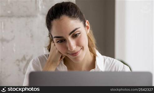 front view smiley businesswoman working laptop