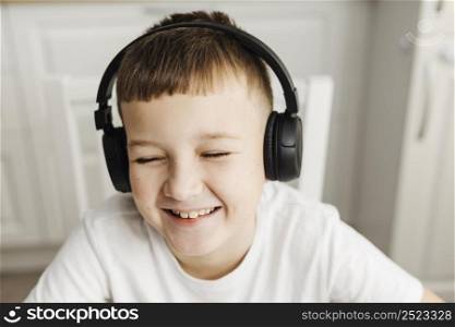 front view smiley child wearing headphones