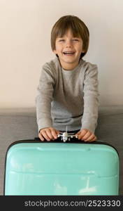 front view smiley child with luggage