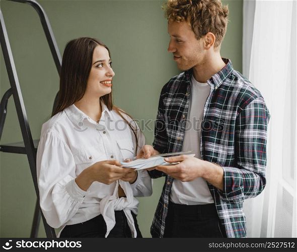 front view smiley couple making plans redecorate house