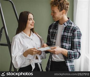 front view smiley couple making plans redecorate house