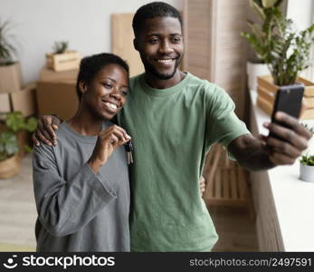 front view smiley couple taking selfie their new home