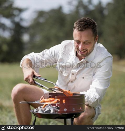 front view smiley man attending barbecue outdoors
