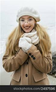 front view smiley woman outdoors beach winter