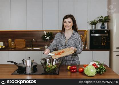 front view smiley woman preparing food kitchen
