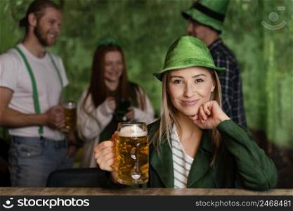 front view smiley woman with hat celebrating st patrick s day with drink friends