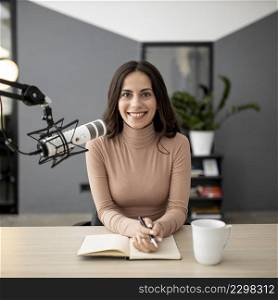 front view smiley woman with microphone radio studio