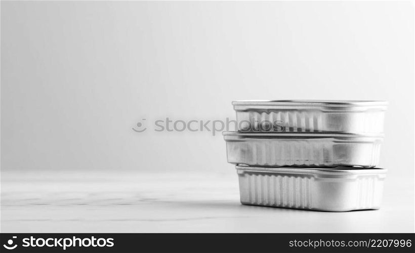 front view stack silver tin cans with copy space