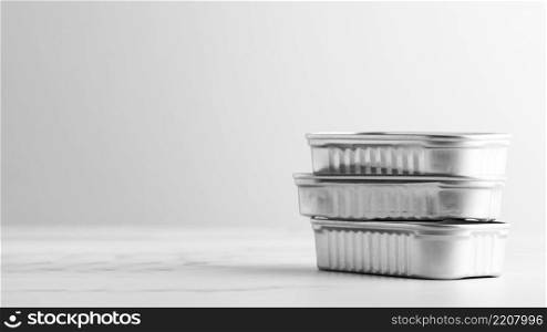 front view stack silver tin cans with copy space