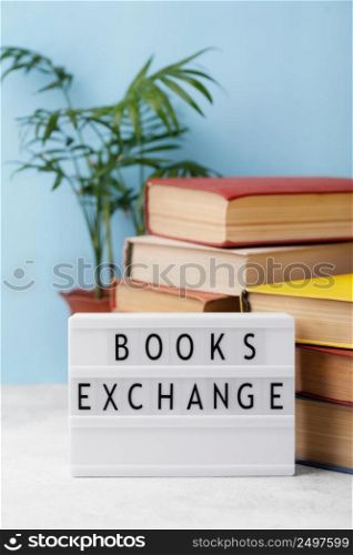 front view stacked books with plant light box