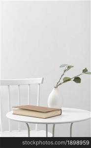 front view table with book vase. Resolution and high quality beautiful photo. front view table with book vase. High quality beautiful photo concept