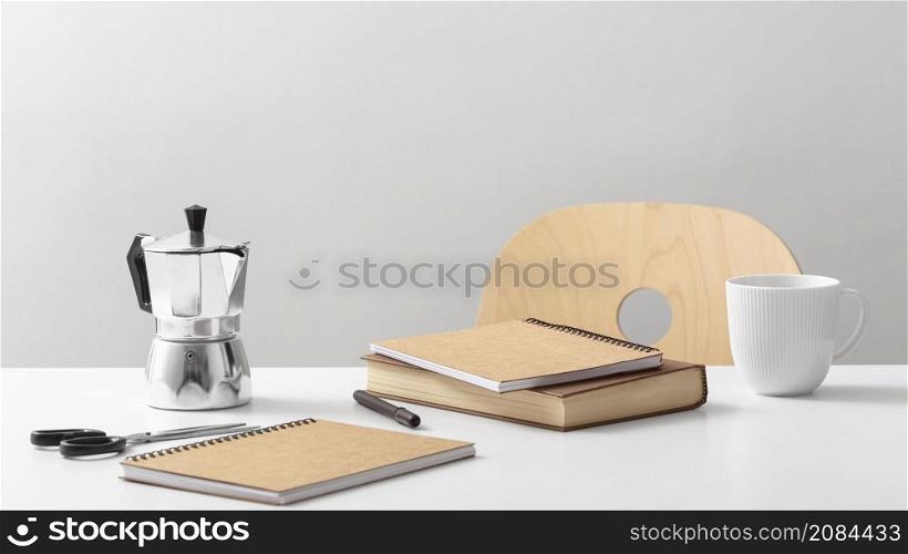 front view table with notebooks kettle