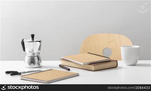 front view table with notebooks kettle