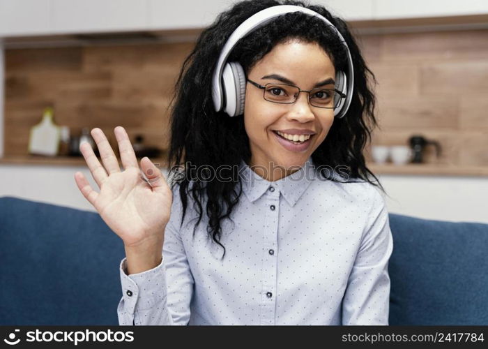 front view teenage girl with headphones during online school