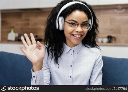 front view teenage girl with headphones during online school
