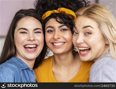 front view three happy women posing together smiling