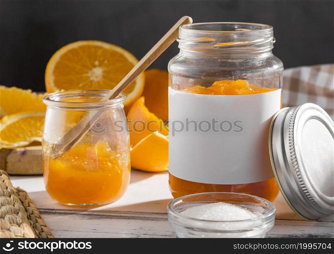 front view transparent jar with orange jam