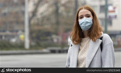 front view woman city wearing medical mask with copy space
